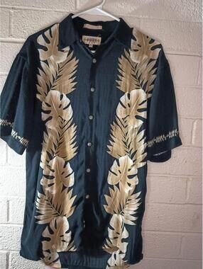 Campia Moda black short-sleeve button-up shirt featuring a beige tropical...